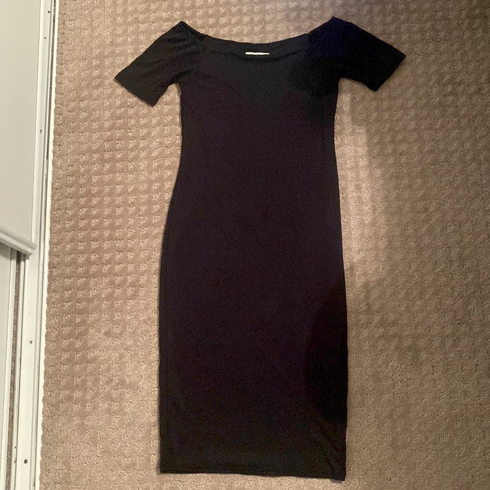 Knee length, tightly fitted black dress.
